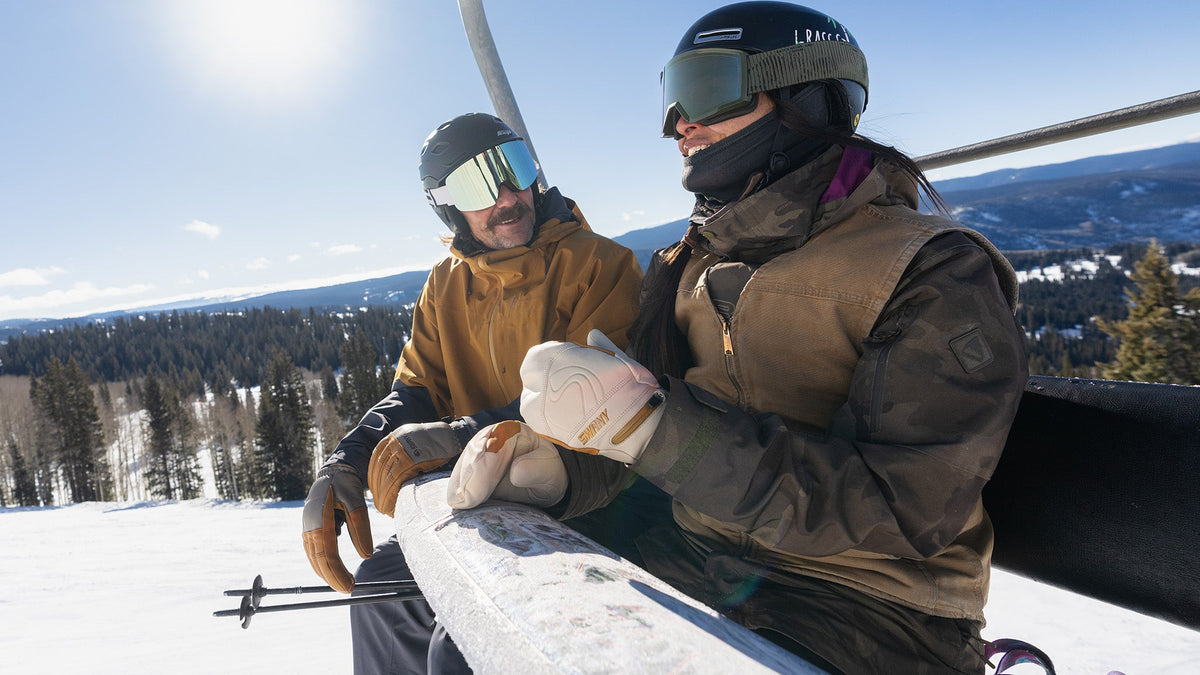 Skier wearing Swany ski mittens on a chairlift