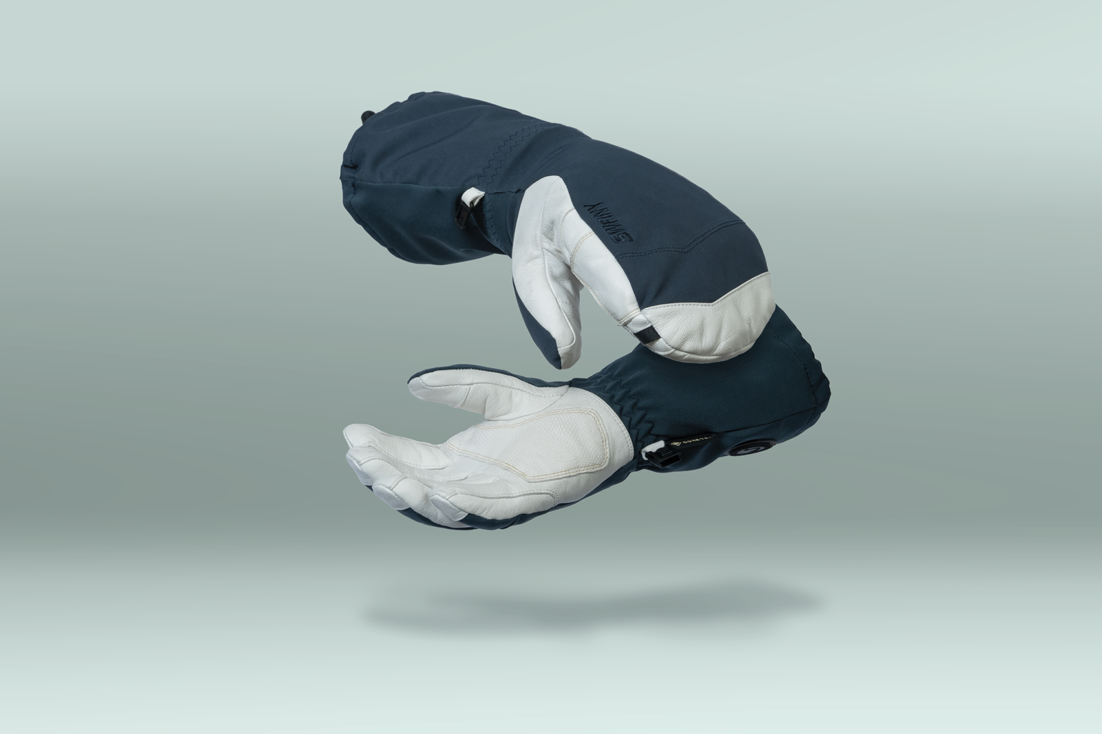 Pair of dark blue and white gloves on a light gray background